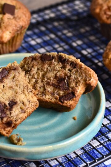 finished banana muffins served on a blue plate.