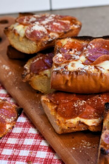 serving the pizza with Parmesan dusted on top.