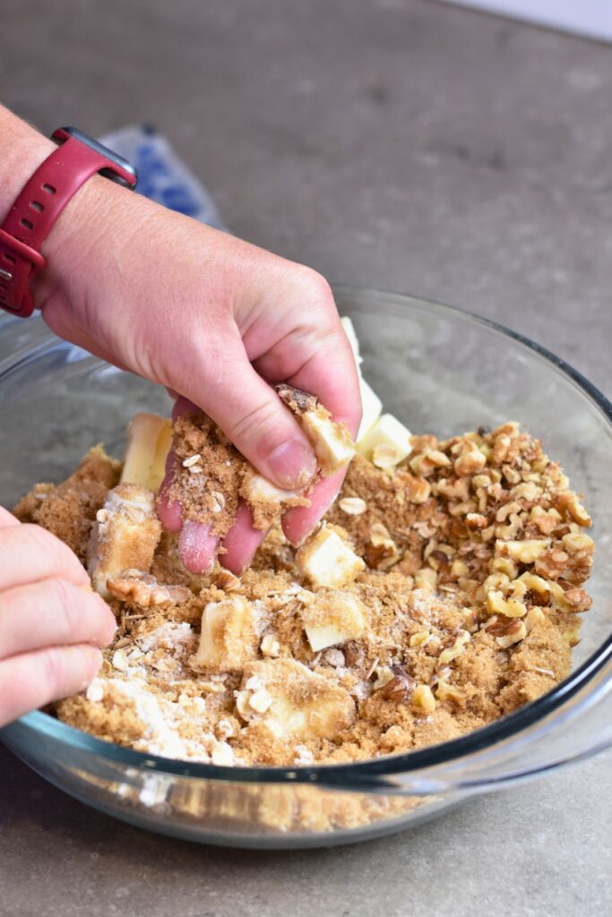 blending-the-cold-butter-and-oat-mixture-together mixing the butter with the oat mixture.