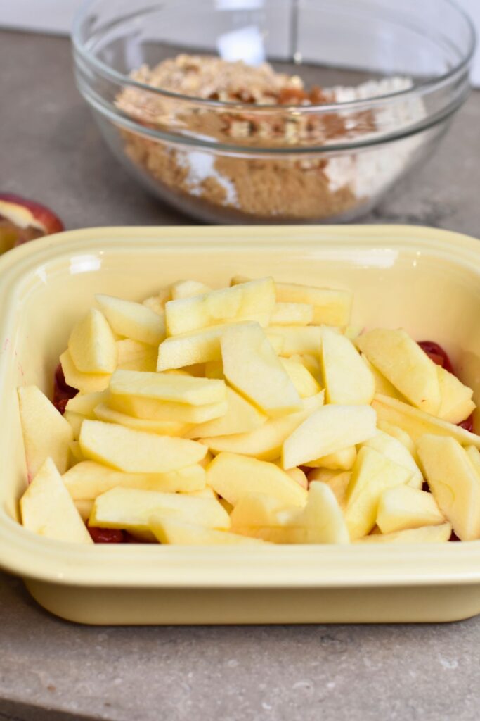 Slicing the apples and placing them in the baking dish.