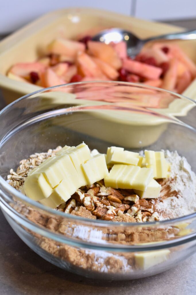 Slicing the cold butter and adding it to the crumble mixture.