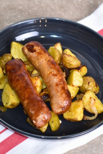 serving the brats with a bed of potatoes.