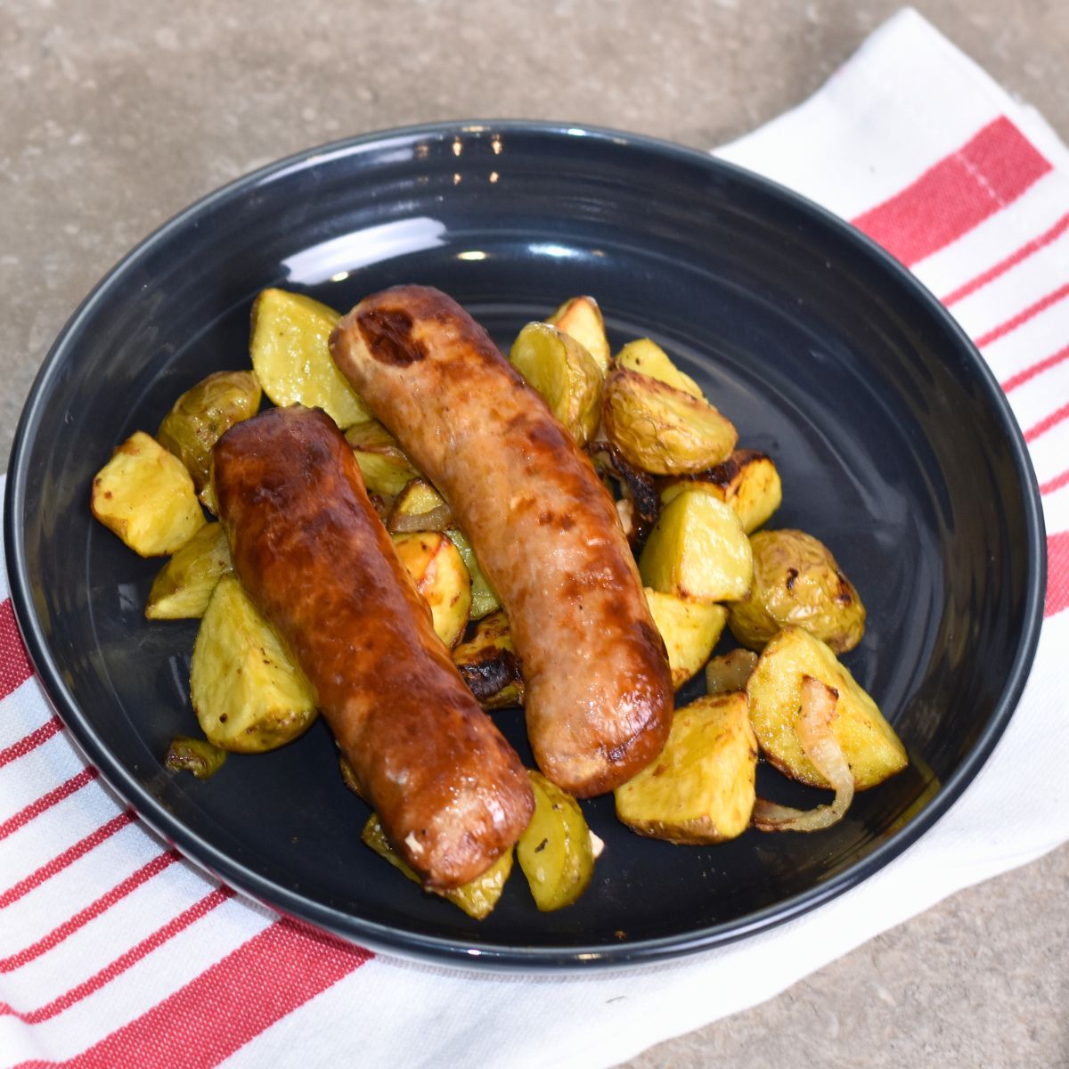 serving the brats with a bed of potatoes.