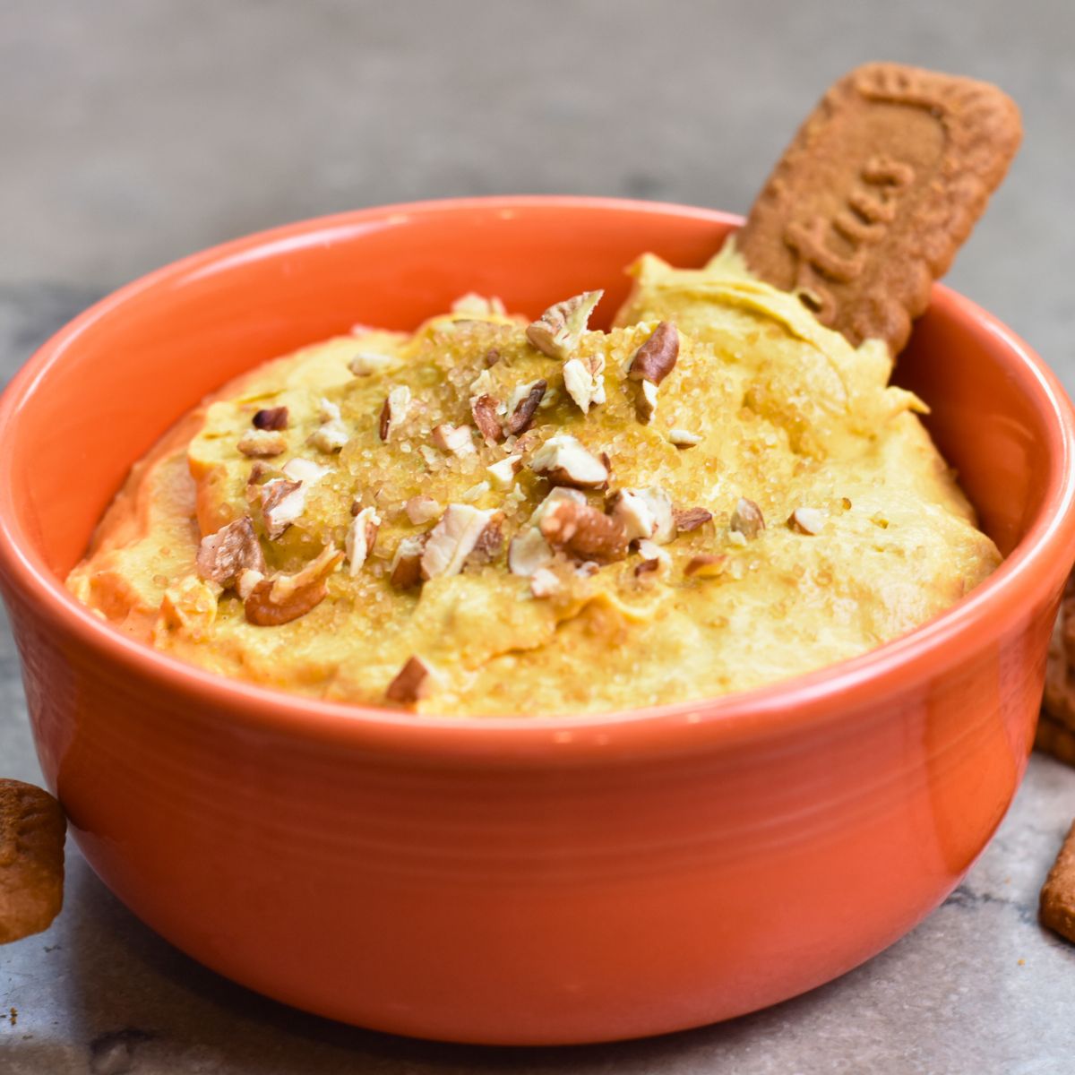 serving-this-pumpkin-dip-to-my-thanksgiving-guest Topping the pumpkin dip with brown sugar and chopped pecans.