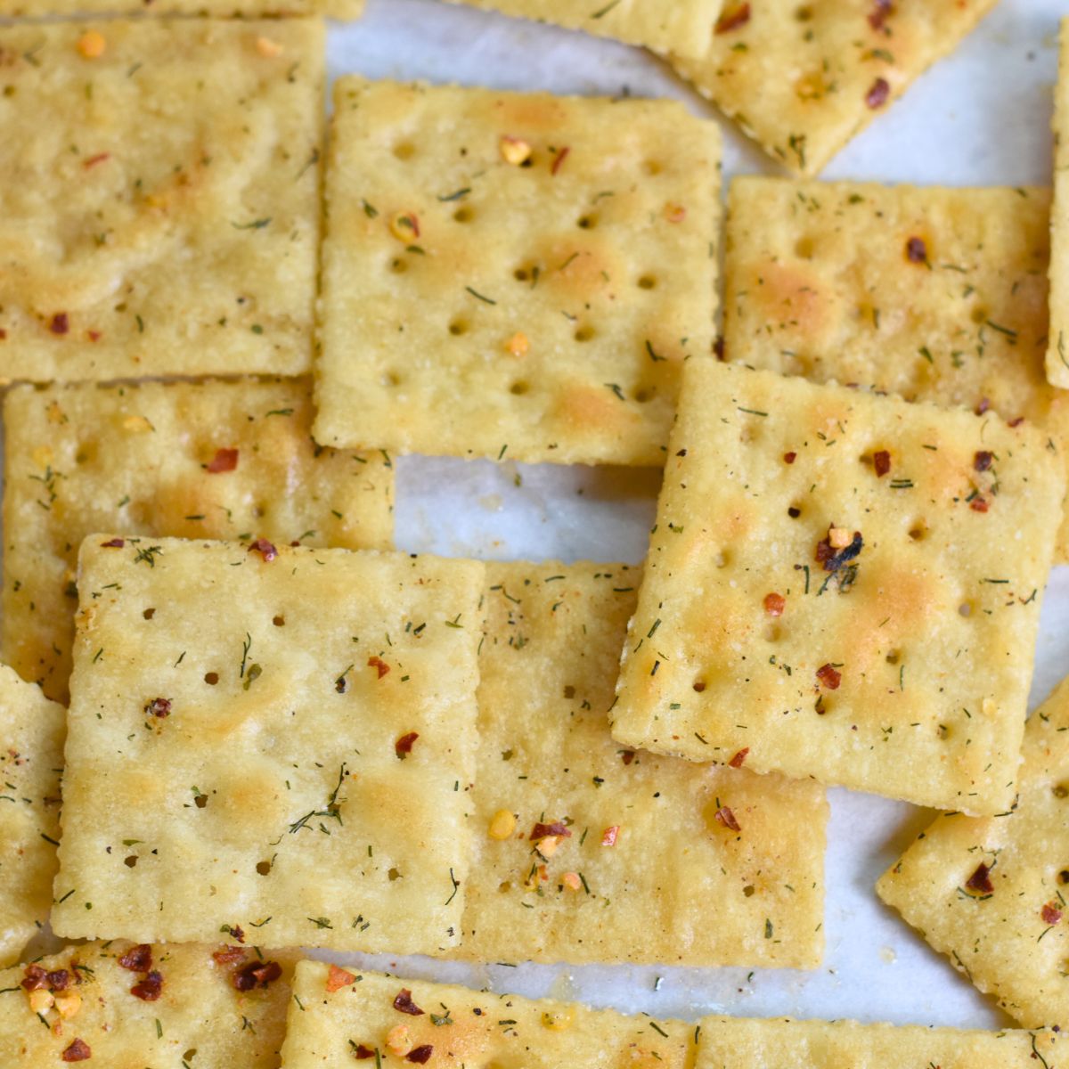 Freshly-baked-Cajun-Crackers-on-parchment-paper Fresh out of the over cajun crackers being served at the holiday party.