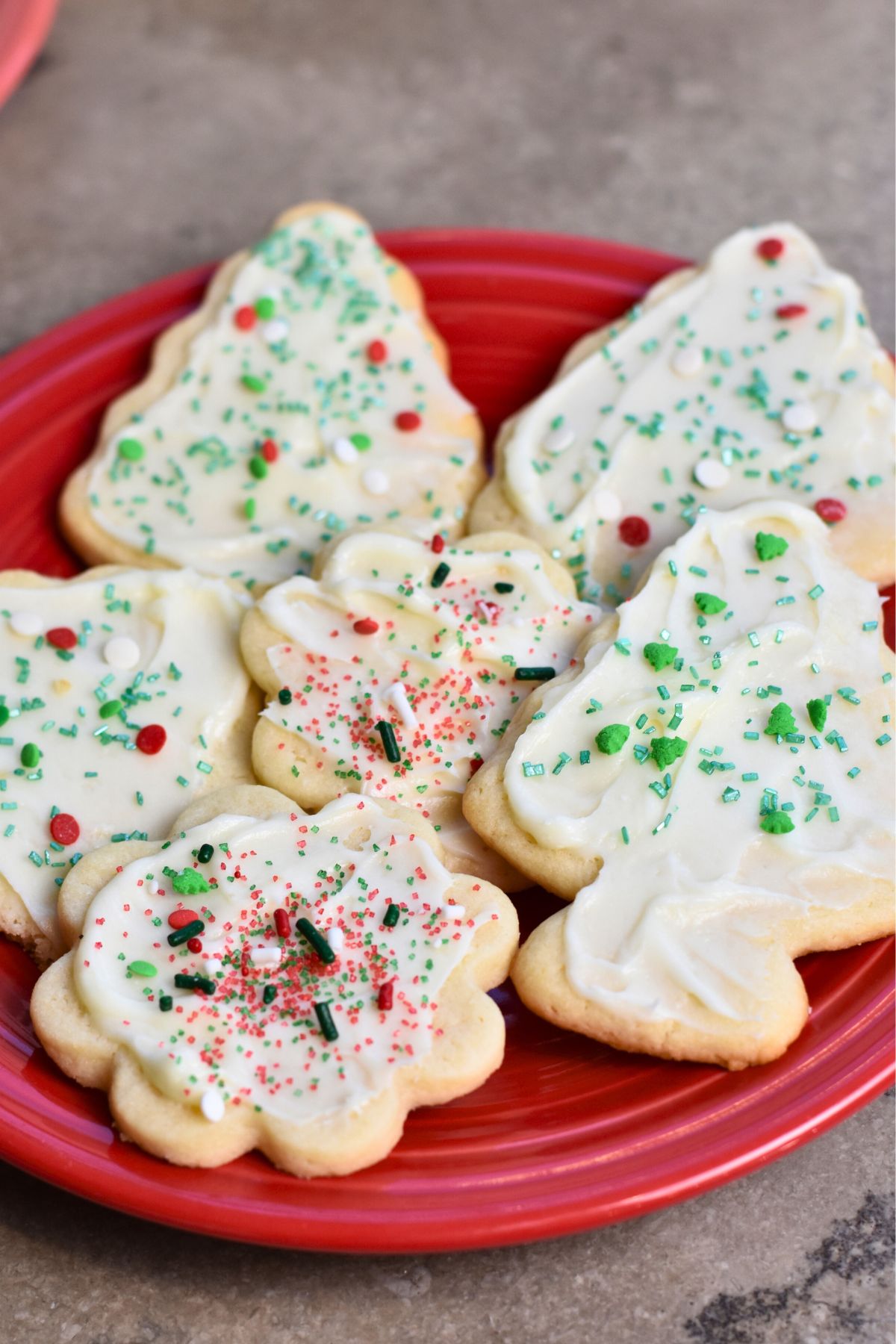 Sugar-cookies-with-cream-cheese-frosting-served-on-a-white-platter Sugar cookies served on a red plate.