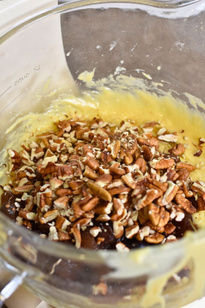 adding-the-pecans-into-my-batter sprinkling the pecans into the batter.