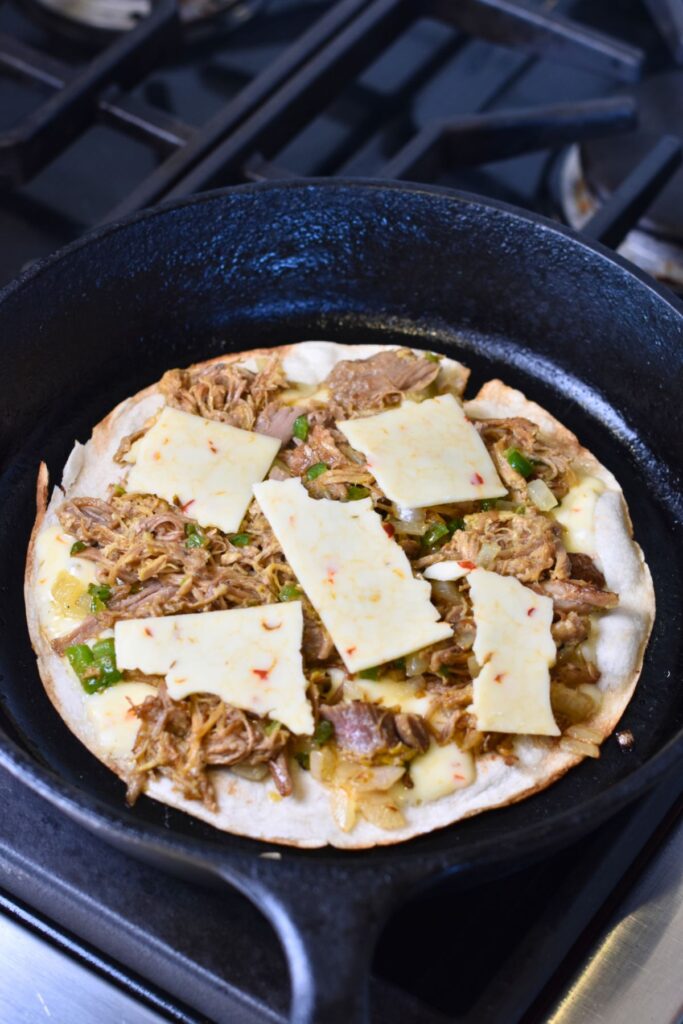 Toasting-the-quesadilla-until-warm-and-crispy Add the pepper jack cheese to the tortilla.