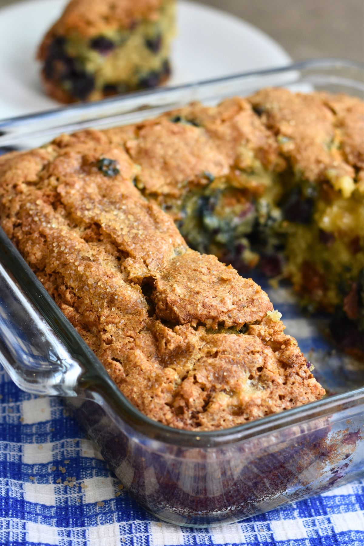 butter-blueberry-bread Crispy blueberry banana bread being cut into slices.