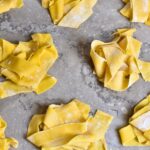 Homemade pappardelle pasta is ready to be cooked.