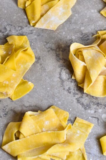 Homemade pappardelle pasta is ready to be cooked.
