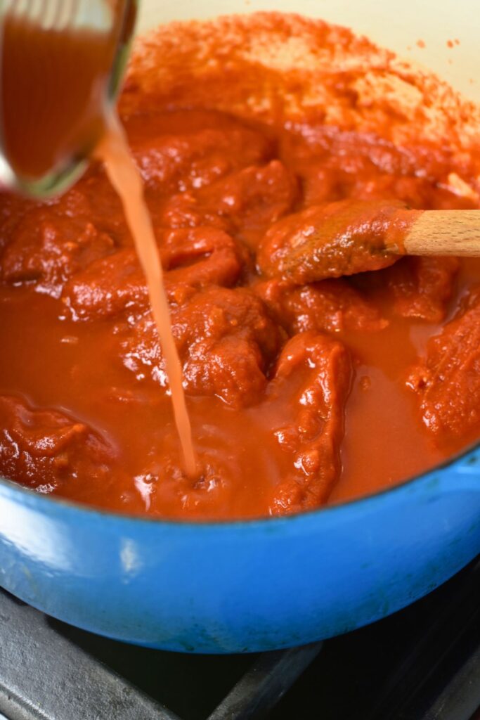 add-water-to-the-red-sauce Adding-water-into-the-homemade-red-sauce