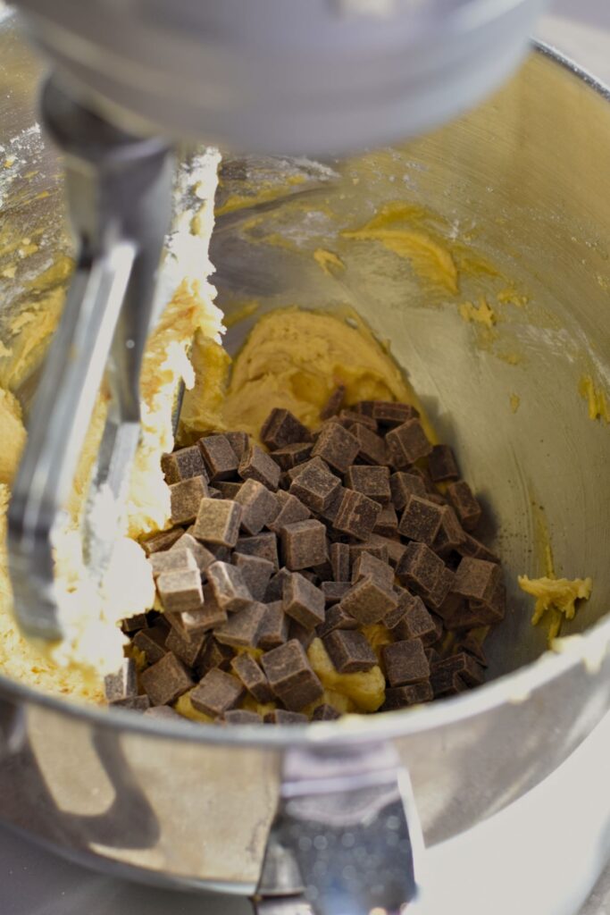 Mix-in-the-chocolate-chunks-into-the-dough Folding in the chocolate chunks into the dough.