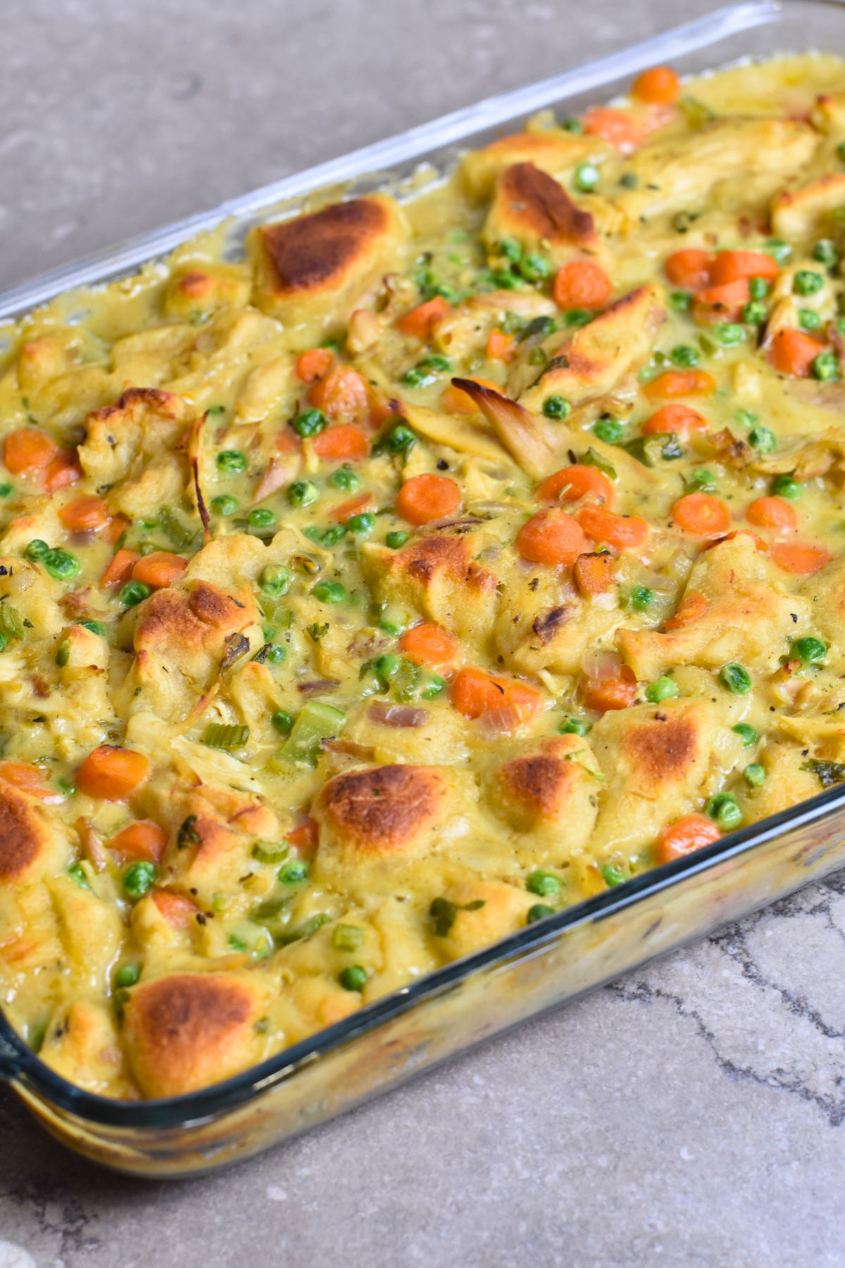 serving-chicken-biscuit-casserole-to-my-family Serving the golden brown chicken biscuit casserole.