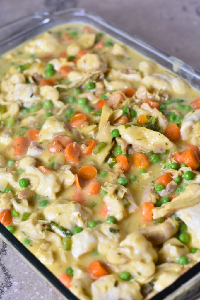 pour-the-mixture-into-a-casserole-dish-and-bake-in-the-oven pouring the chicken biscuit mixture into a casserole dish.