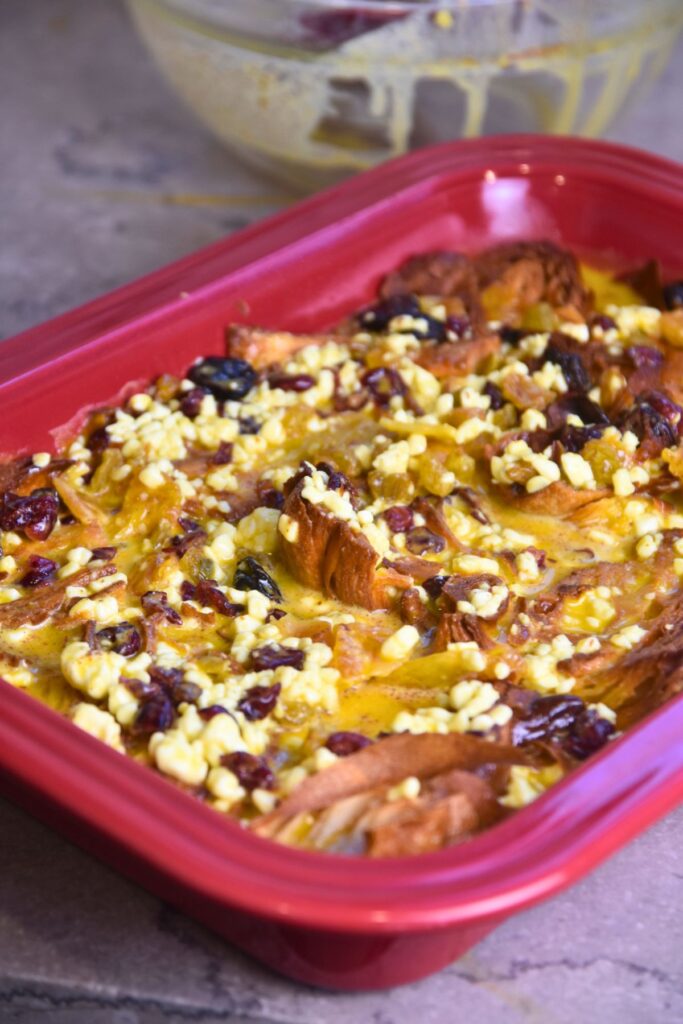 Croissant-breakfast-casserole-ready-to-go-into-the-oven Pour the egg and cottage cheese mixture over the top of the croissants.