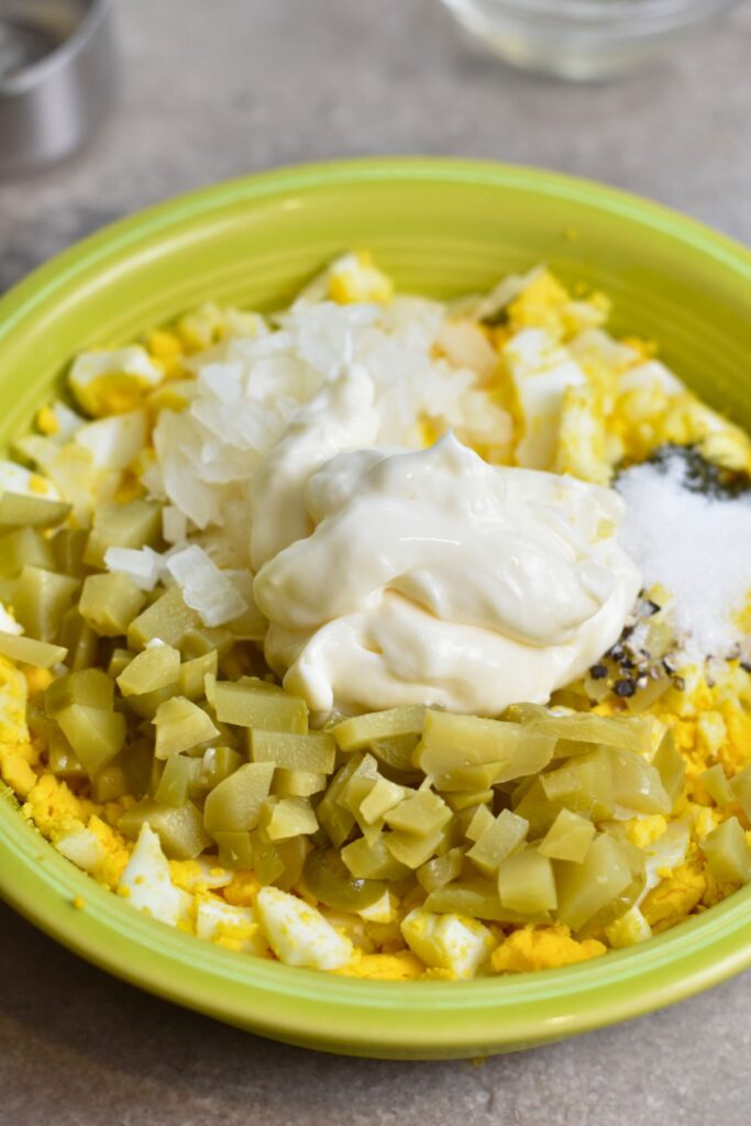 Add-mayo-to-egg-salad-and-mix-well Add all of the ingredients to a bowl and mix until well combined.