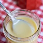 Scooping the syrup out of a jar.