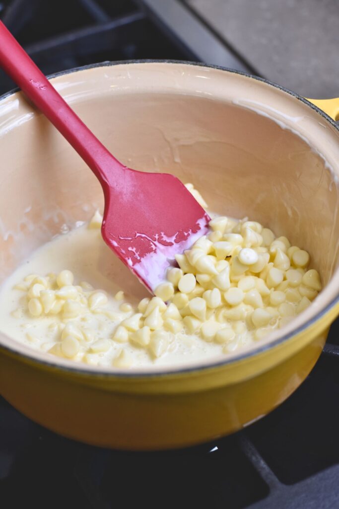 mixing-the-white-chocolate-chips-until-they-are-melted Mixing the white chocolate chips with the heavy whipping cream.