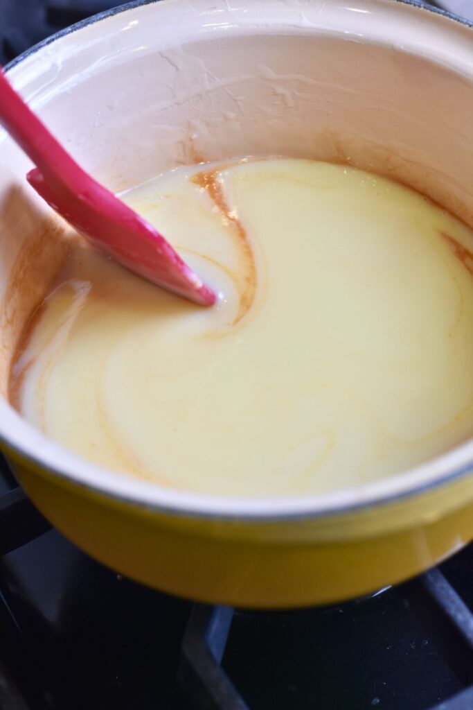 mix-in-the-extracts-into-the-melted-chocolate-mixture Mixing in the vanilla and almond extract into my syrup mixture.