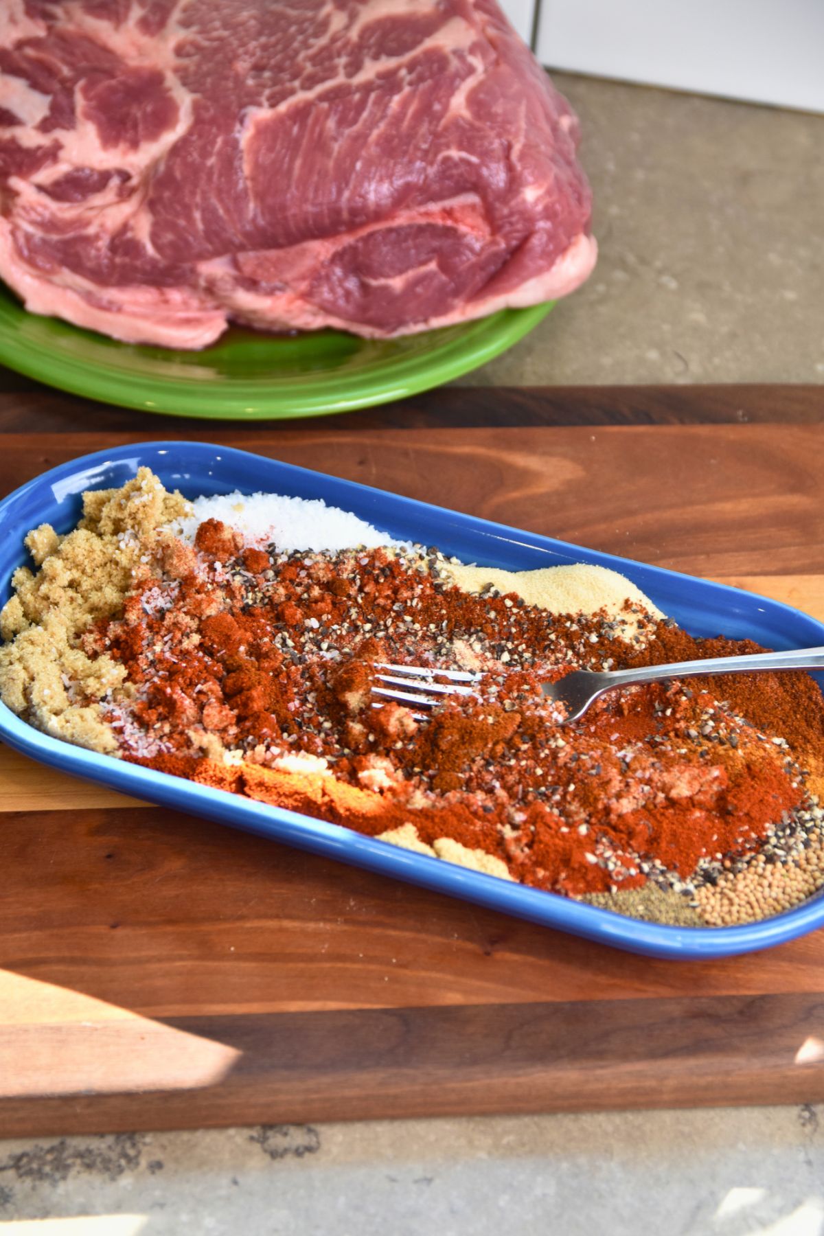 mixing-the-rub-to-blend-all-of-the-ingredients-together mixing the pulled pork rub with a fork.