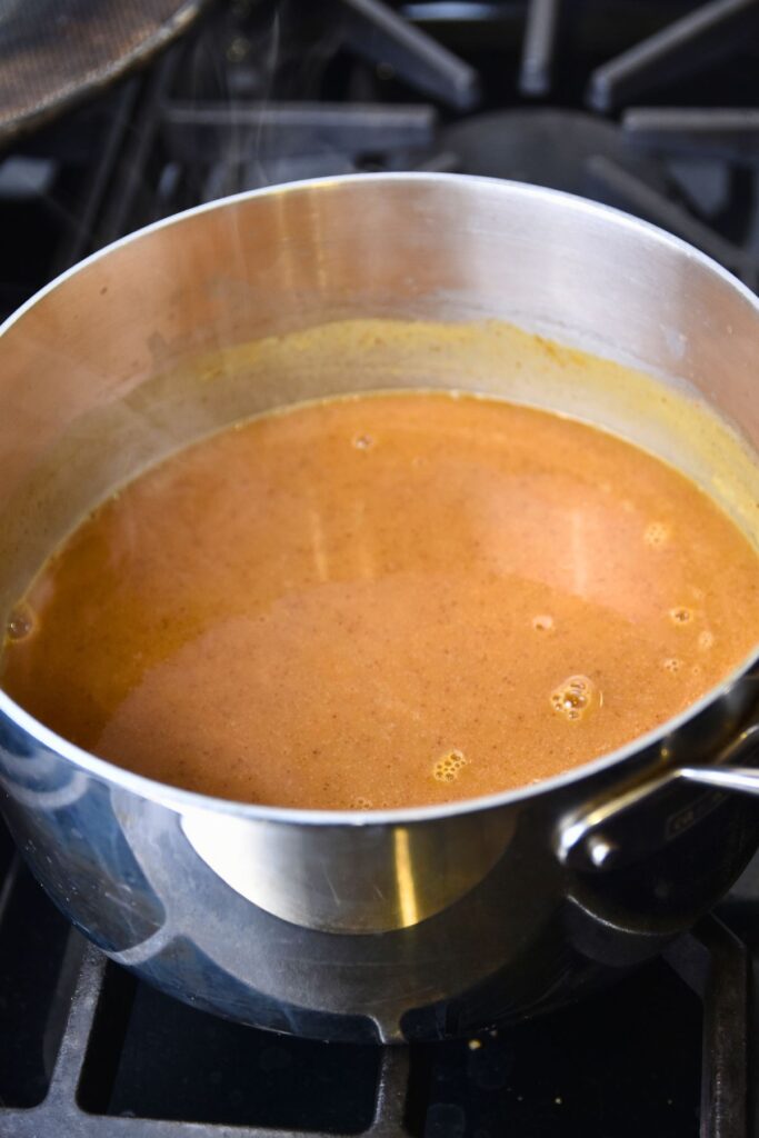 cooking-the-enchilada-sauce-until-it-thickens Bring the burrito enchilada sauce to a simmer.