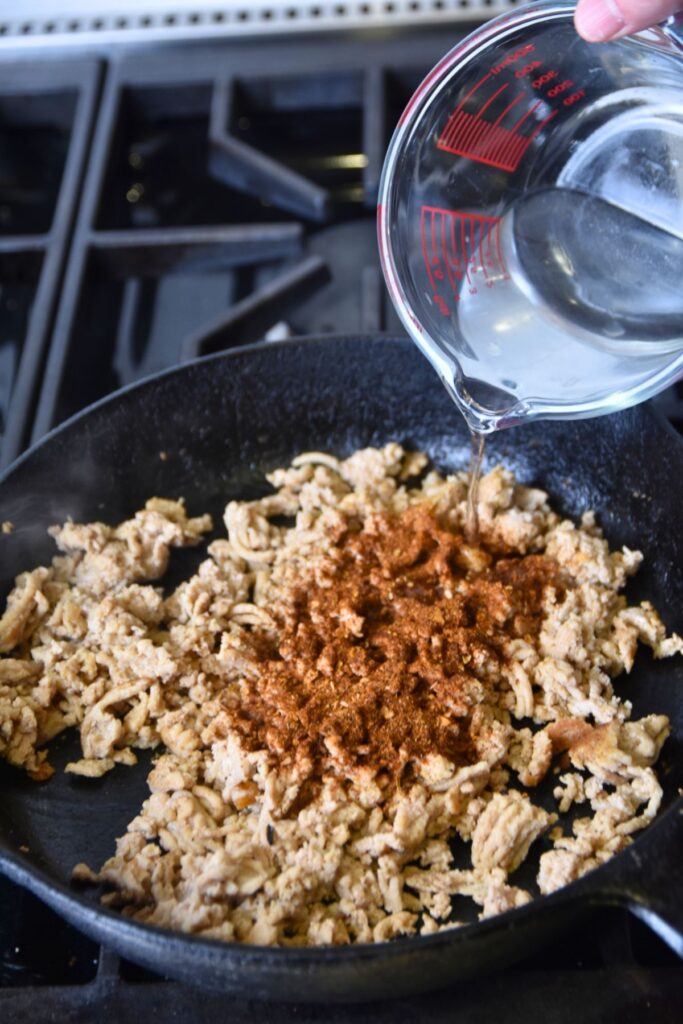Seasoning-the-ground-meat-with-taco-seasoning-for-burrito-enchilada-style Season your ground meat with taco seasoning.