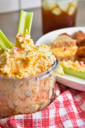 ready-to-eat jalapeno pimento cheese being served in a glass bowl.