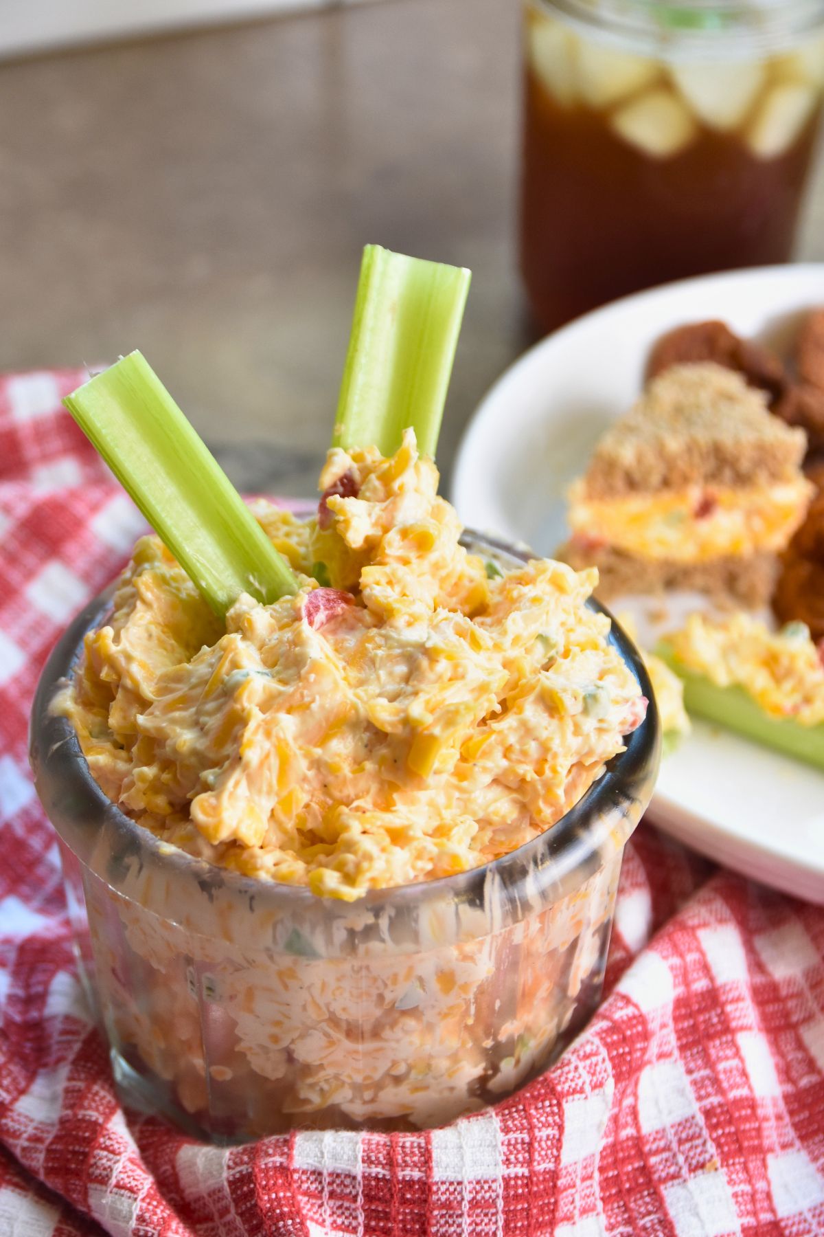 Serving-jalapeno-pimento-cheese-on-a-red-and-white-table-cloth Serving jalapeno pimento cheese to house guests.