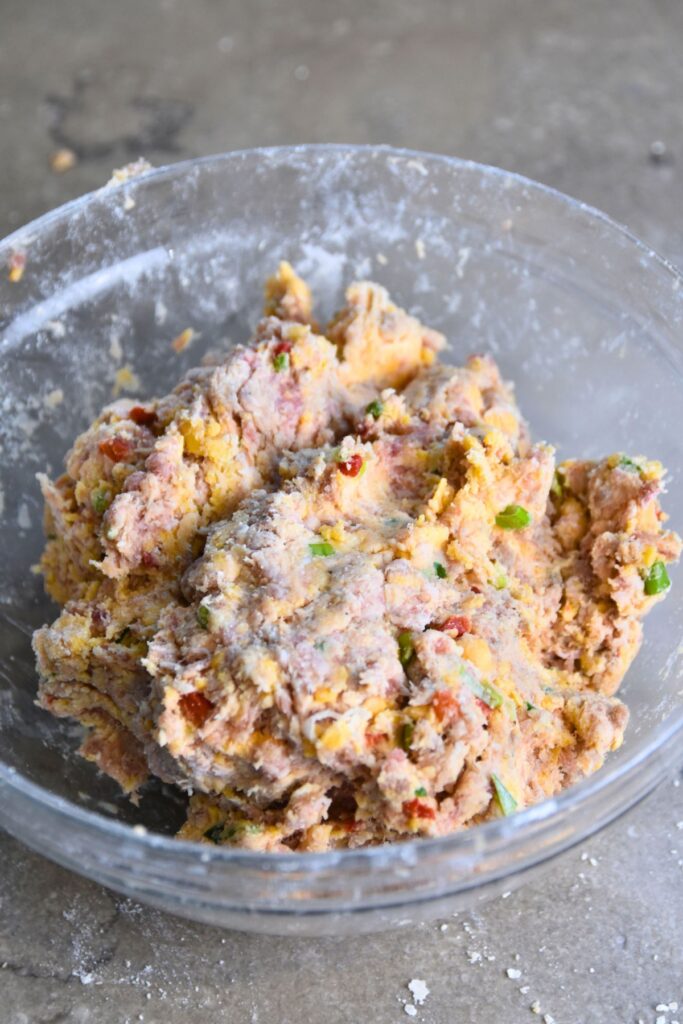Scoop-and-bake-the-pimento-cheese-balls Form the pimento cheese sausage balls into balls.