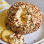 eating the pineapple cheese ball on a cracker.