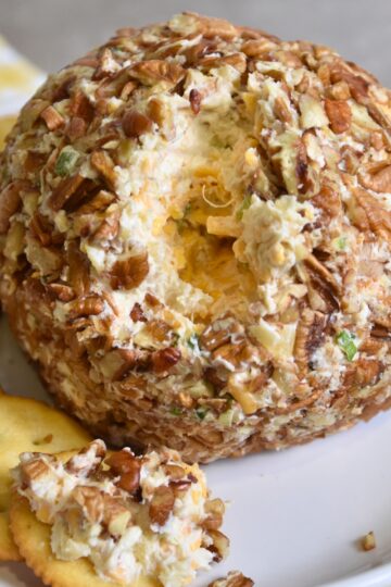 eating the pineapple cheese ball on a cracker.