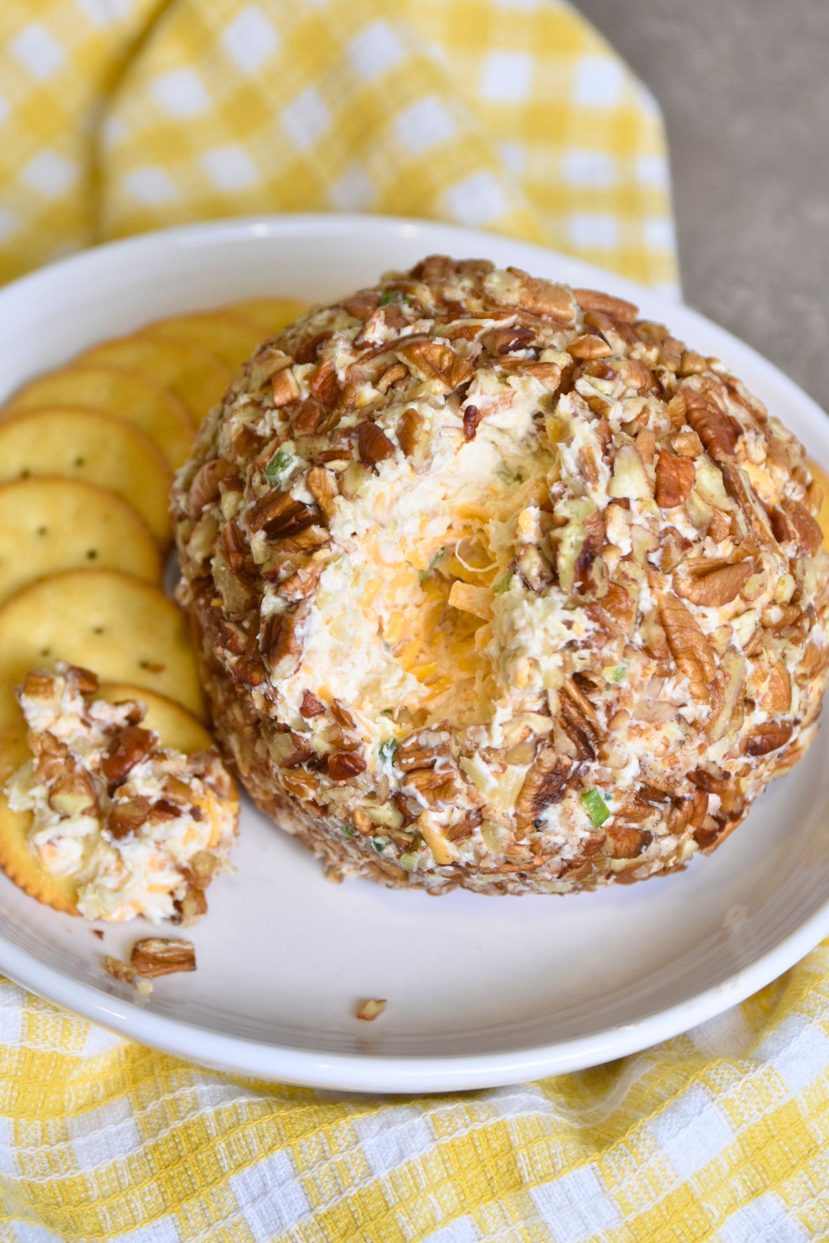 Ready-to-eat-pineapple-cheese-ball Serving pineapple cheese ball with round crackers.