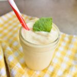 Serving the pineapple slushy with a mint leaf as garnish.