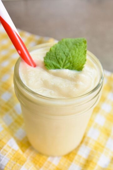 Serving the pineapple slushy with a mint leaf as garnish.