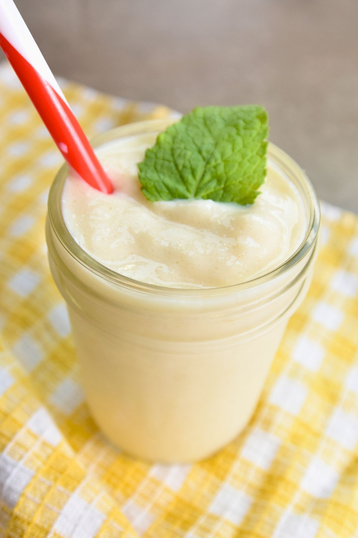 this-pineapple-slushy-is-the-perfect-summer-treat Pineapple slushy served in a mason jar.