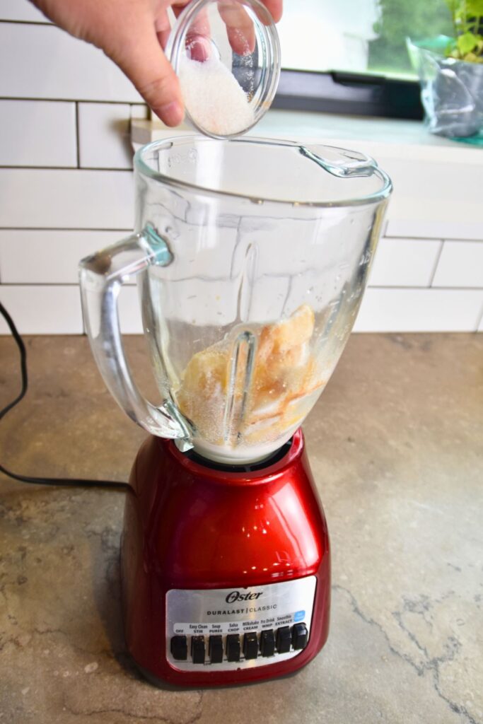 Blending-the-sugar-and-the-pineapple-mint-leaf Adding the sugar into the pineapple mixture.