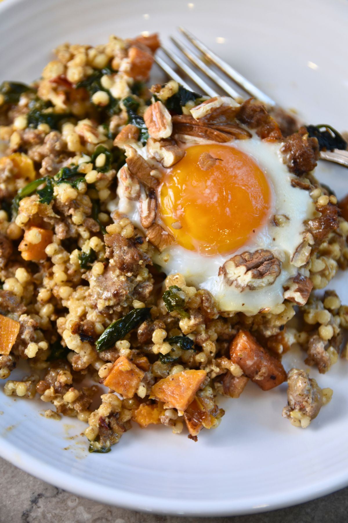 Colorful-sorghum-breakfast-casserole-served-on-a-white-plate Sunny egg served in a sorghum breakfast skillet.