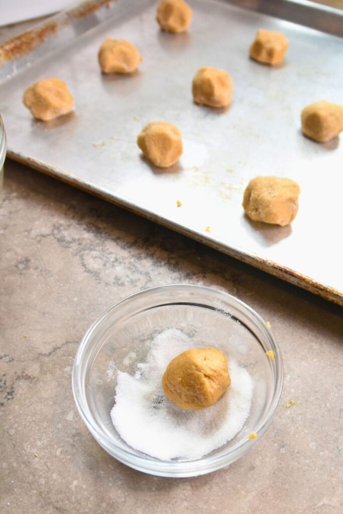 roll-the-cookie-dough-balls-in-sugar-and-bake Roll the ball of the dough in sugar.