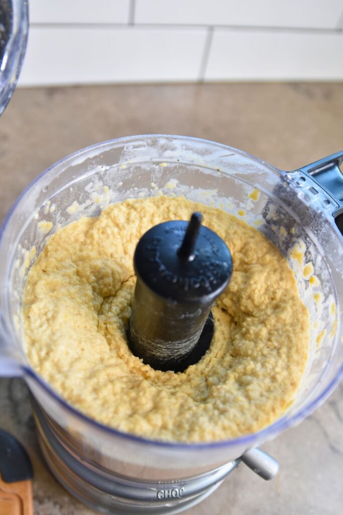 Blend-the-chickpeas-and-garlic-in-a-food-processor Blended chickpeas until smooth and creamy.