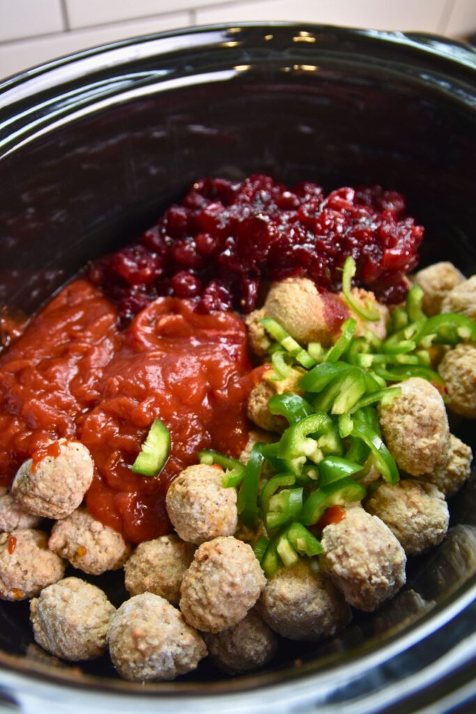 Mix-all-the-ingredients-in-the-crock-pot Adding all of the ingredients into the crock pot.