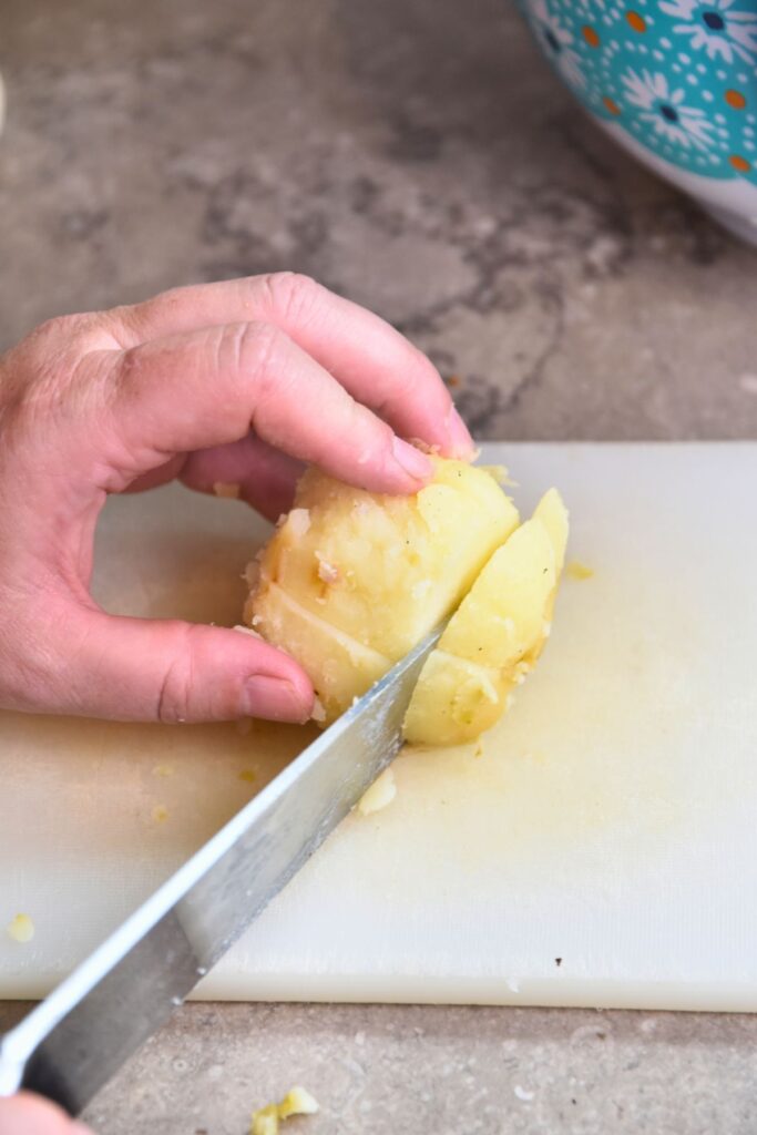 cut-and-peel-the-red-potatoes-while-they-are-hot Cut the hot red potatoes into cubes.