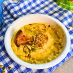 Serving pumpkin cauliflower soup with toast.