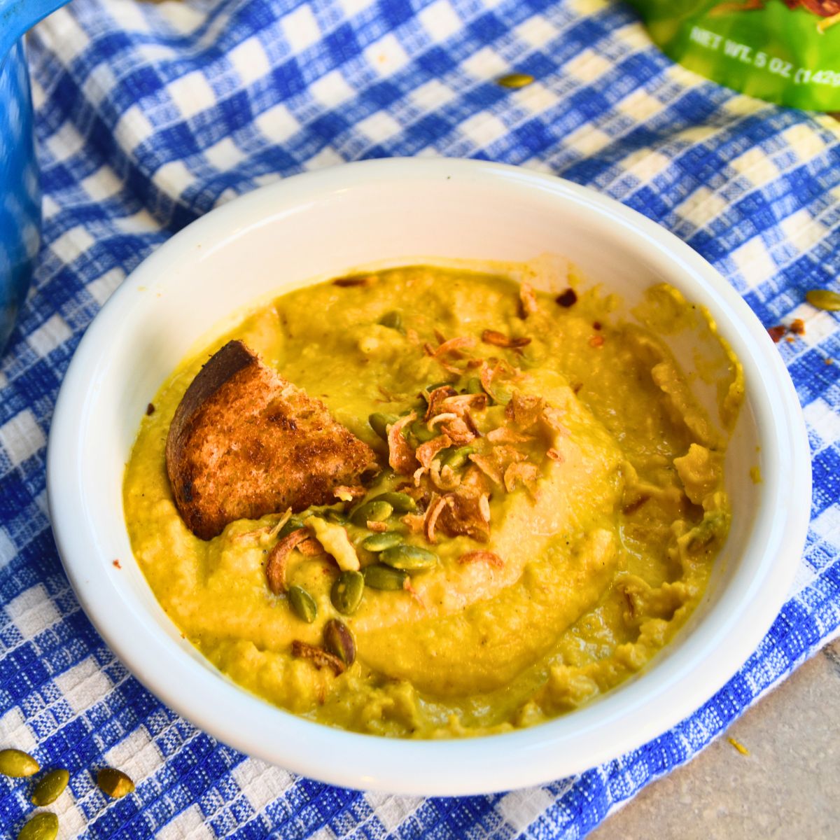 Serving pumpkin cauliflower soup with toast.