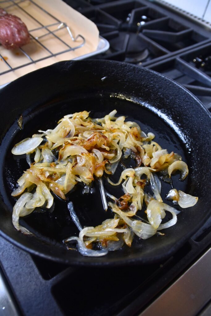 Grilling-the-onions-in-a-cast-iron-skillet Golden caramelized onions.