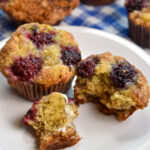 two blackberry banana muffins on white plate