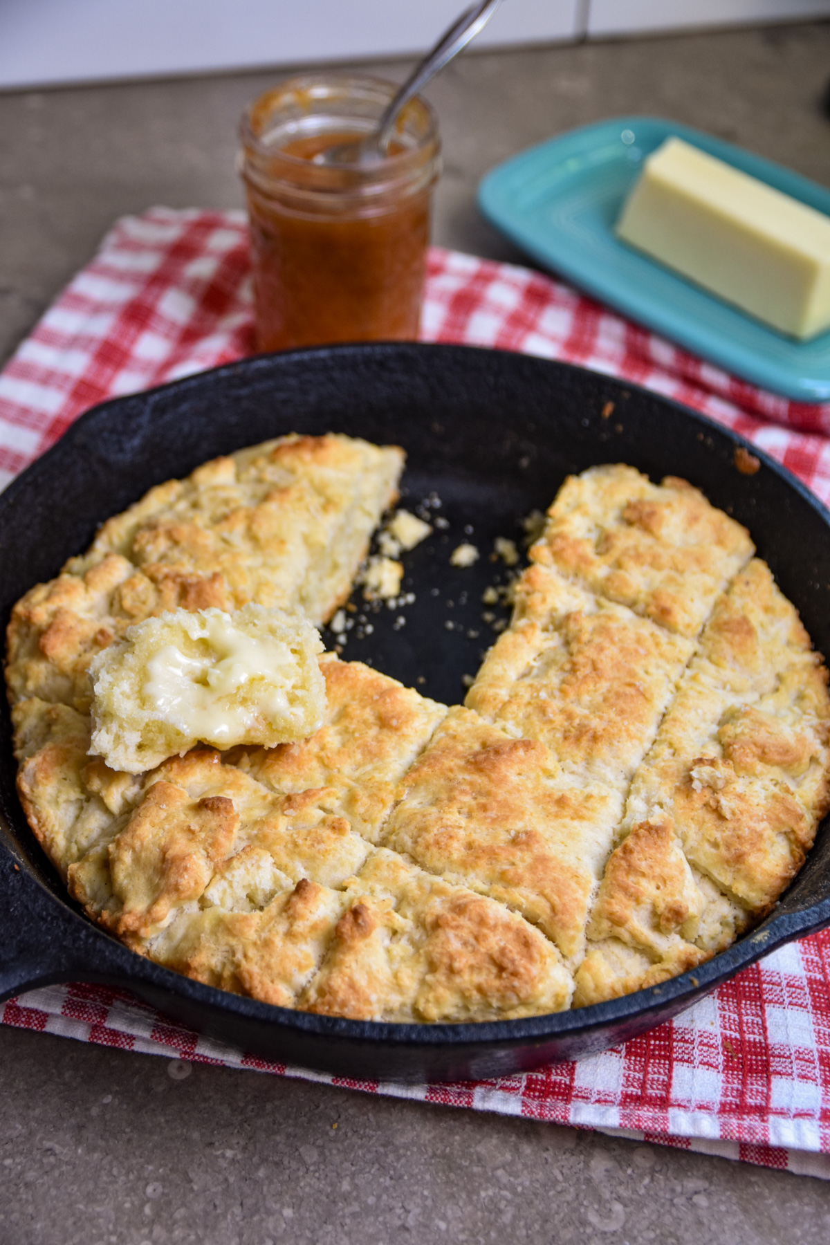 buttered-biscuit Buttered biscuit on pan of skillet biscuits