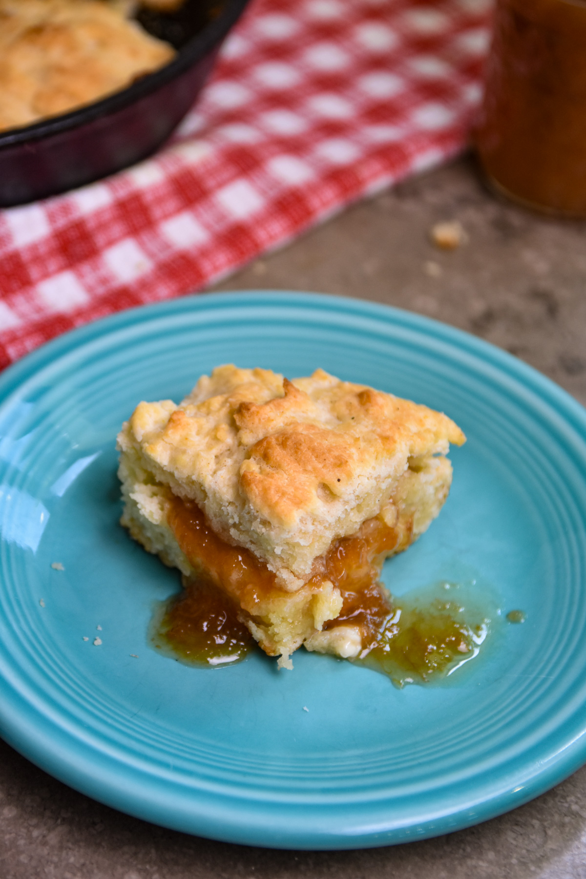 jam-on-biscuit Skillet biscuit on small plate with peach jam