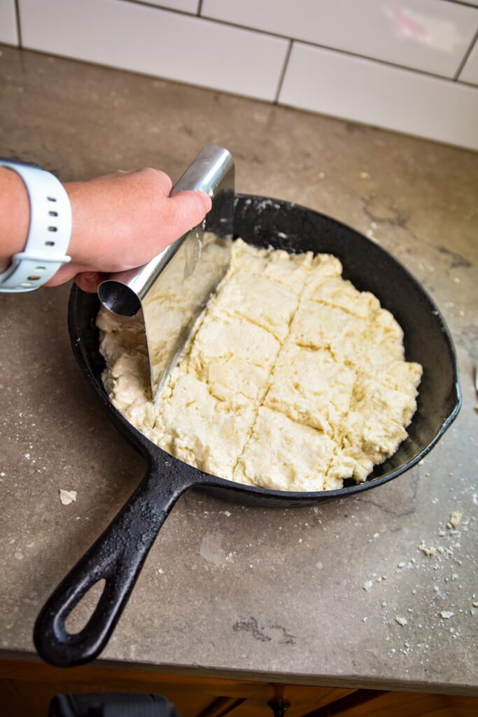 scoring-biscuits-before-baking Cutting skillet biscuits with pastry bench before baking