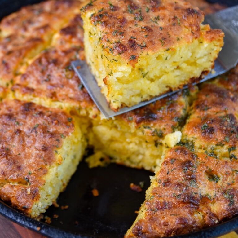 Serving one golden brown cheddar bay biscuit on a spatula.